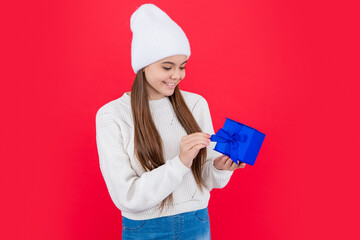 new year holiday. smiling teen girl with new year present in studio. teen girl