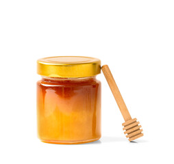 Fresh honey in a jar with a wooden dipper on a white isolated background.
