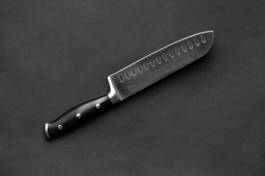 Large kitchen knife on a black background