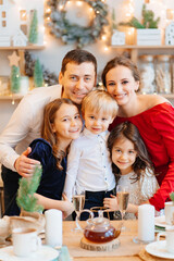 Beautiful big family in the kitchen with Christmas decor. to cook together.