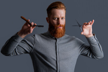 unshaven man with barber scissors in barbershop. barber man in barbershop studio. barber man