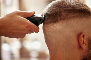 Barber shaving caucasian man in barber shop