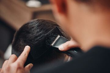 Barber shaving caucasian man in barber shop