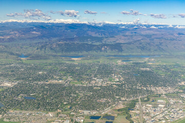 Aerial View of Ft. Collins, Colorado with Snow Capped Rocky Mountains in background.
