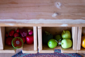 Some toy fruits on wooden boxes on a grocery store