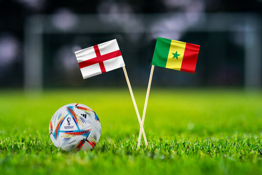 QATAR, DOHA, NOVEMBER 29. 2022: England - Senegal. Eight final, Last 16 football match. Official ball of Fifa world cup Qatar 2022 on green grass. Soccer stadium in background,