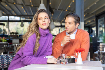 Beautiful couple drinking coffee in cafe bar