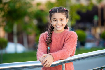 Happy teenage girl in trendy fashion style. Teenage fashion model smiling outdoors. Teenage style
