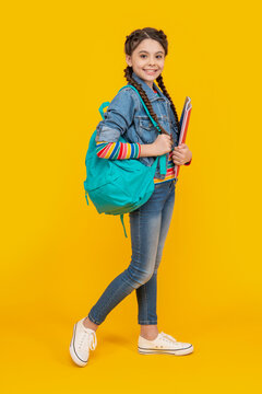 Happy schoolgirl yellow background, school. Teenage girl back to school. September 1. School