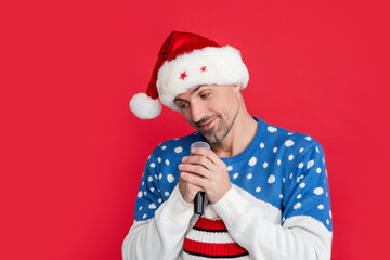 christmas song. shy man singing christmas song with microphone in studio. man singing song