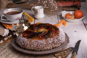 Rosca de reyes, king cake, glazed fruit, Provencal Galette des rois on a wooden table