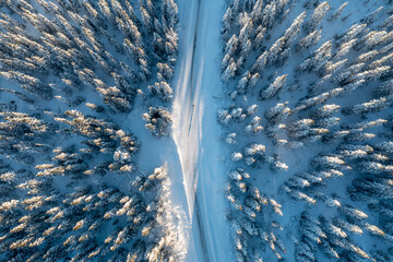 Drone View Of Winter Road trough the forest in Åre, Sweden