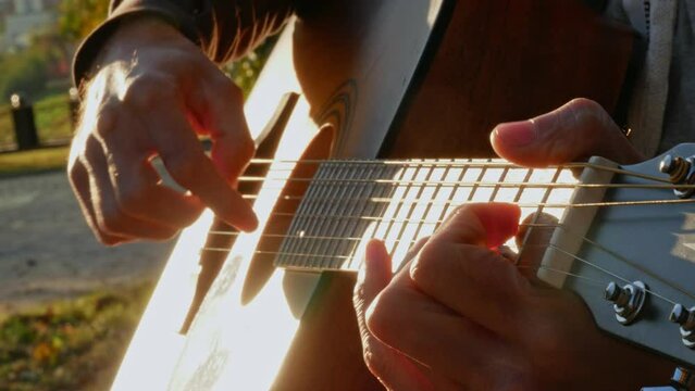 Close-up of an acoustic guitar and guitarist's hands