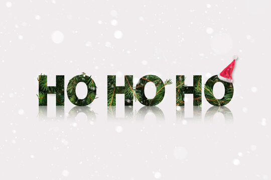 Santa ho ho ho sound made of a fir branch with Santas hat in the end. Winter Christmas theme with snow. - Powered by Adobe