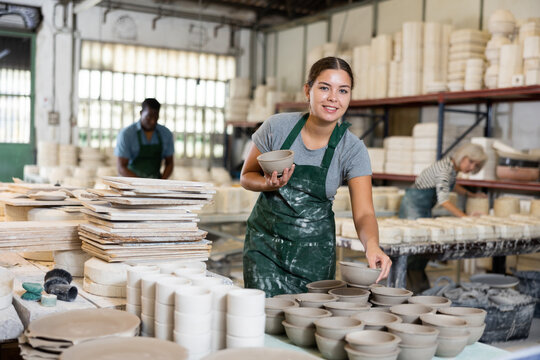 Female potter arrange pottery product at factory ceramic
