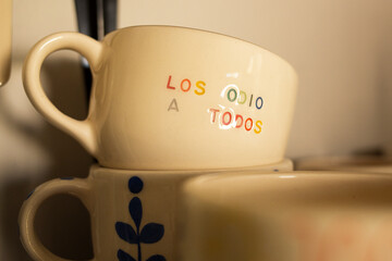 Shelf with handmade ceramic cups with different designs