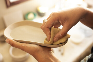 Artist smoothing surface of a craft made at home