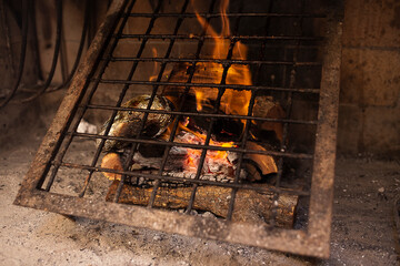 metal grill on wood set on fire