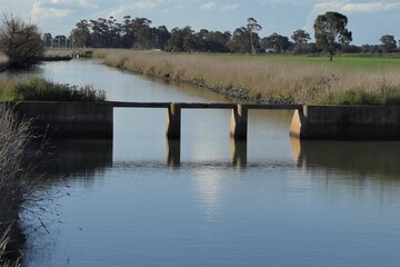 This is a picture of the old method of Fresh water irrigation flow control on a channel. 