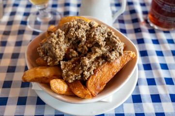 Scottish traditional snack food, hand cut potato chips topped with haggis and gravy