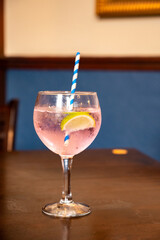 Glass of gin and tonic cocktail served in old vintage Scottisch pub, drinking gin in Edinburgh, UK