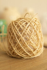roll of natural thread on a wooden table