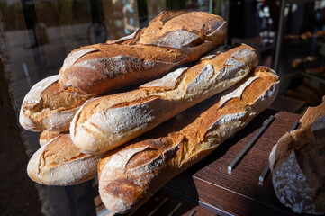 French bakery, many fresh baked baguettes breads ready for sale close up