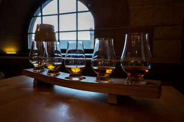 Flight of single malt scotch whisky in glasses served in whiskey bar in Edinburgh, UK