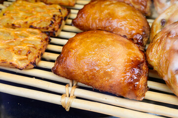 French bakery, fresh baked sweet buns and rolls on display in small French bakery in Paris