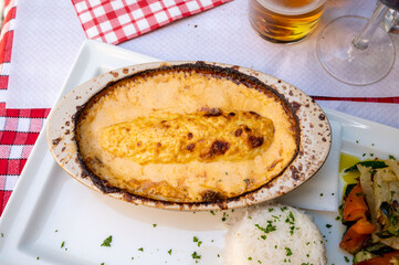 Quenelle, speciality of Lyon, oval-shaped dumplings filled with pike white fish served in creamy sauce in traditional Lyonnaise Bouchon, France