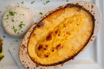 Quenelle, speciality of Lyon, oval-shaped dumplings filled with pike white fish served in creamy...