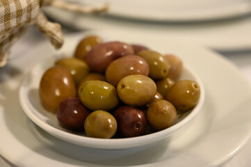 Tasty green olives close up, healthy vegetarian food background