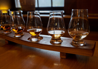 Flight of single malt scotch whisky in glasses served in whiskey bar in Edinburgh, UK