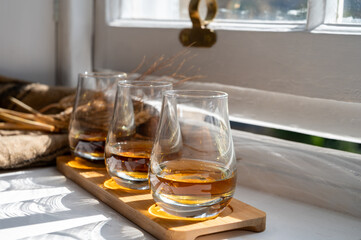 Flight of single malt scotch whisky served on old wooden window sill in Scottisch house in Edinburgh, Scotland, UK