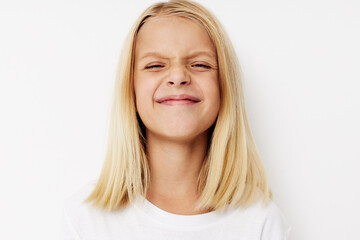 Little cute girl in a white t-shirt grimace cropped view