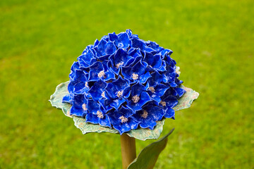 Beautiful garden decoration, a flower replica made of ceramic, (a blue Hydrangea replica).