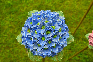 Beautiful garden decoration, a flower replica made of ceramic, (a light blue Hydrangea replica).