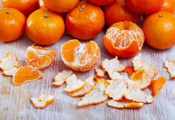 Fresh whole and sectioned clementines on wooden background. Vitamin cooking ingredients © JackF