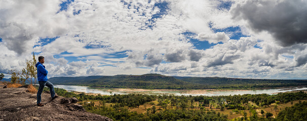 Tourists watch the atmosphere, sky and clouds above the mountain at Pha Taem, Ubon Ratchathani, Thailand