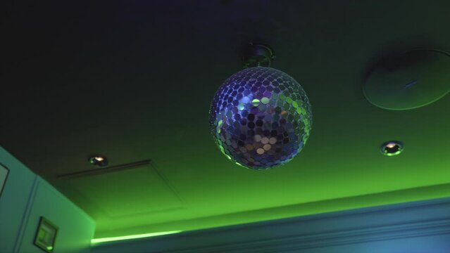 This video shows a spinning disco ball in a colorful neon room.