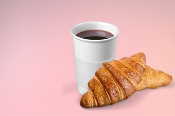 Coffee paper cup with fresh tasty croissant