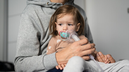 one child toddler girl using steam inhaler nebulizer at home