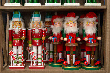 Line of Nutcracker Soldiers in red uniform. Wooden Christmas figurines on the shelf. Santa...