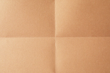Fototapeta premium Folded kraft paper sheet as background, top view