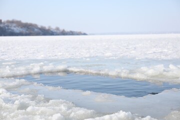 Fototapeta na wymiar Ice hole in river on winter day. Baptism ritual
