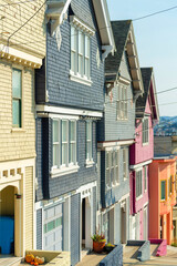 Obraz premium Row of muliticolored modern houses in San Francisco California with wood slatted exterior in suburban neighborhood