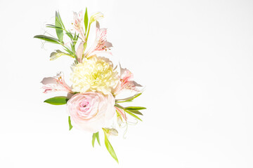 Delicate flower arrangement with flowers and leaves. Summer festive background. Copy space, flat lay.