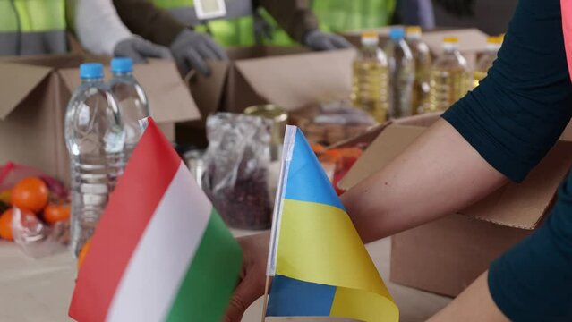 Donations For Ukraine. Ukraine War Refugees. Aid Workers Handing Out Food And Supplies, Budapest, Hungary