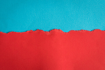 Torn half sheet red paper horizontal on blue paper at the bottom. As template for message or...