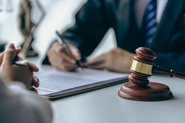Office with sledgehammer in front, lawyers and clients discussing court issues or justice at...
